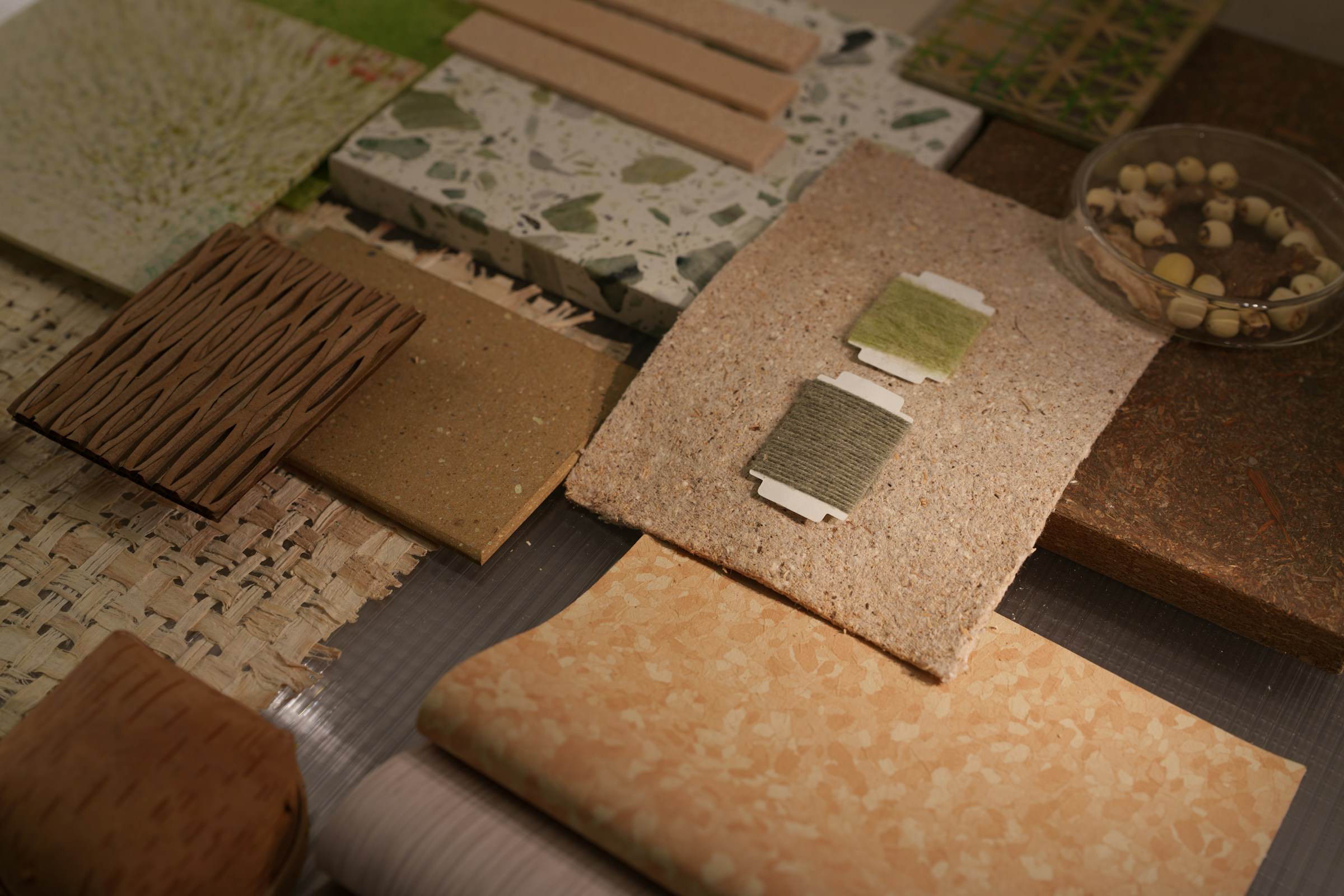 Timber, terrazzo and cork material samples laid out for a design review