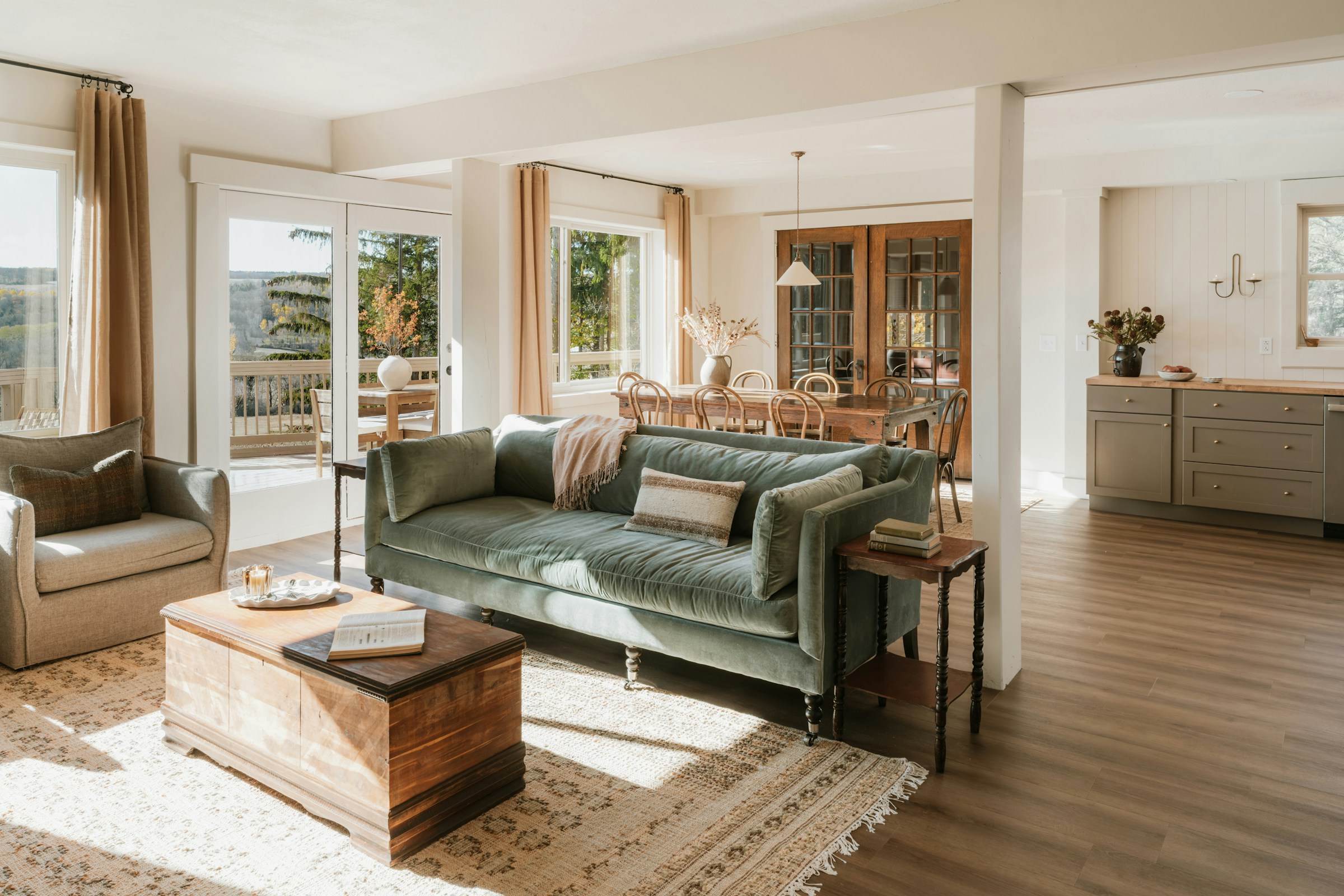 Living room with green sofa, trim detail and warm hardwood floors